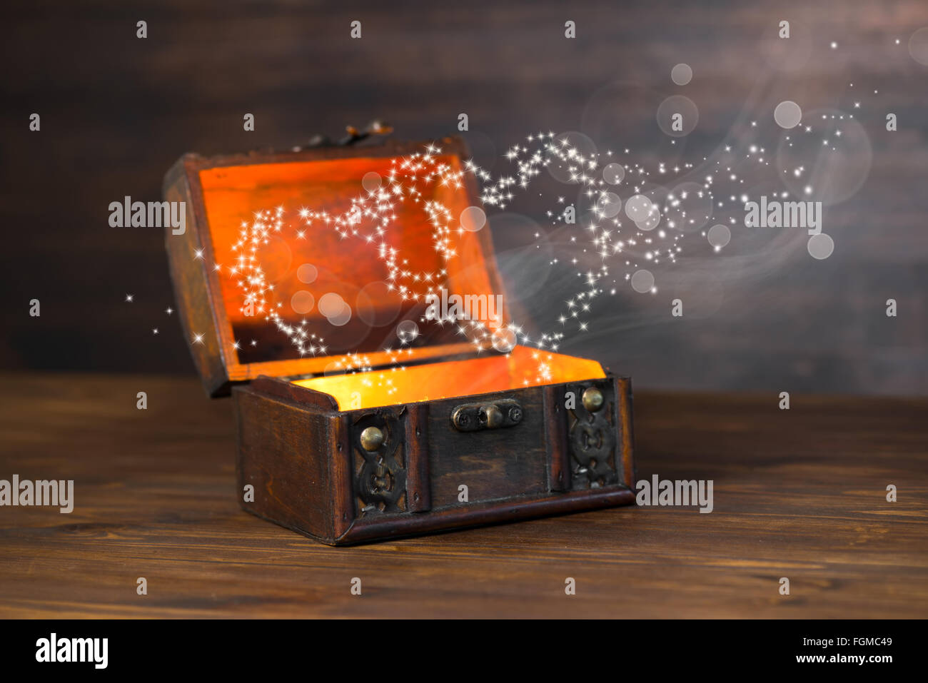 beautiful concept of retro chest with light heart miracle on wooden