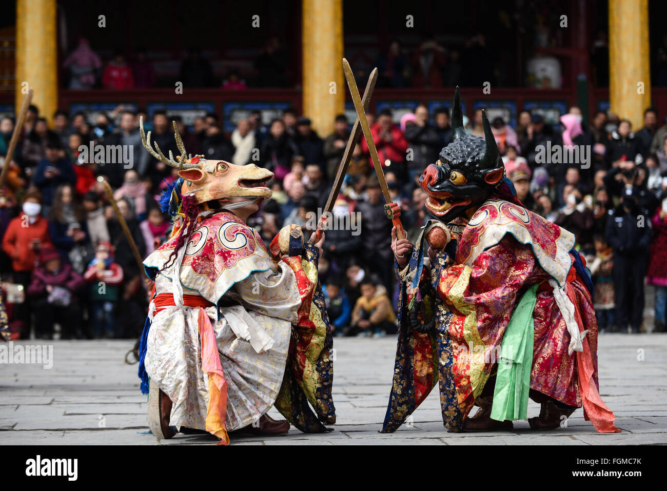 Xining, China's Qinghai Province. 21st Feb, 2016. Monks perform 'Tiaoqian', a masked religious dance with a history of nearly 300 years, at the Kumbum Monastery in Huangzhong County, northwest China's Qinghai Province, Feb. 21, 2016. During the religious ritual, monks will wear colourful traditional clothes and masks, performing dance to scare away evil spirits. Credit:  Wu Gang/Xinhua/Alamy Live News Stock Photo