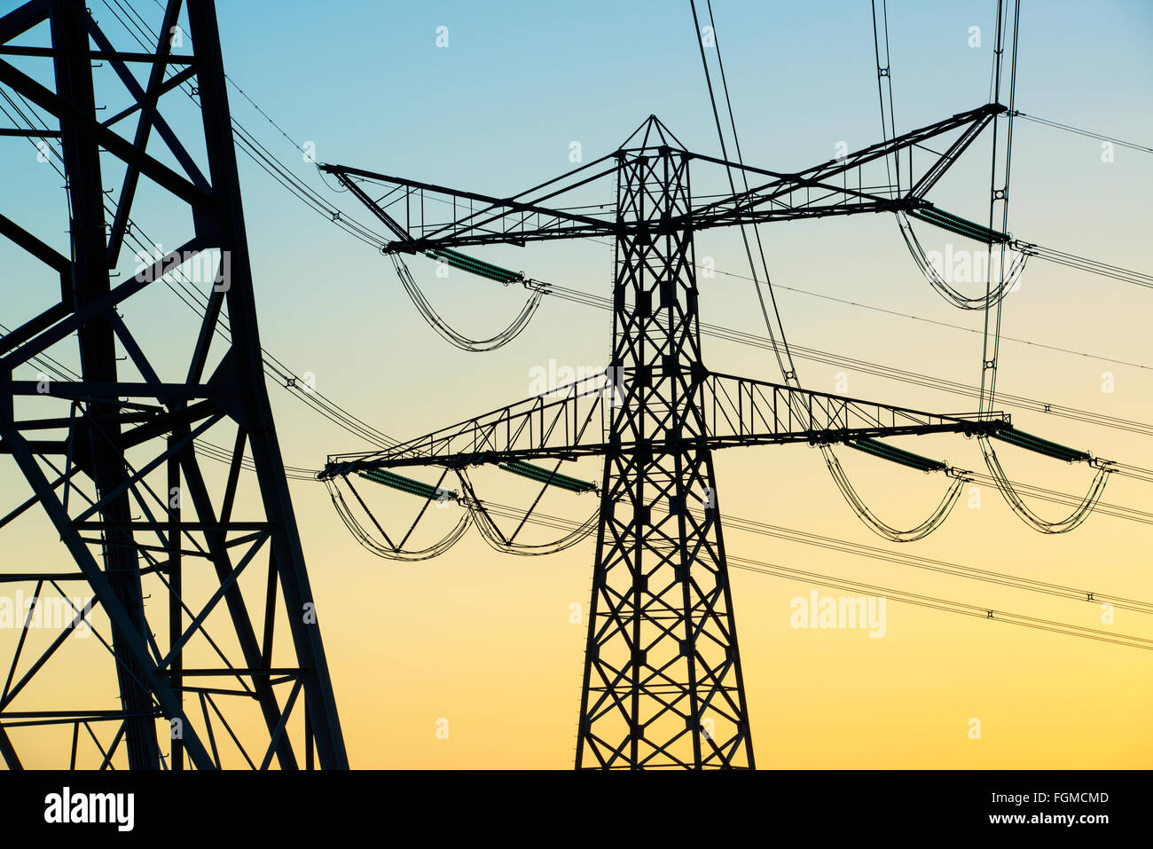 Electricity pylons and lines at dusk Stock Photo - Alamy