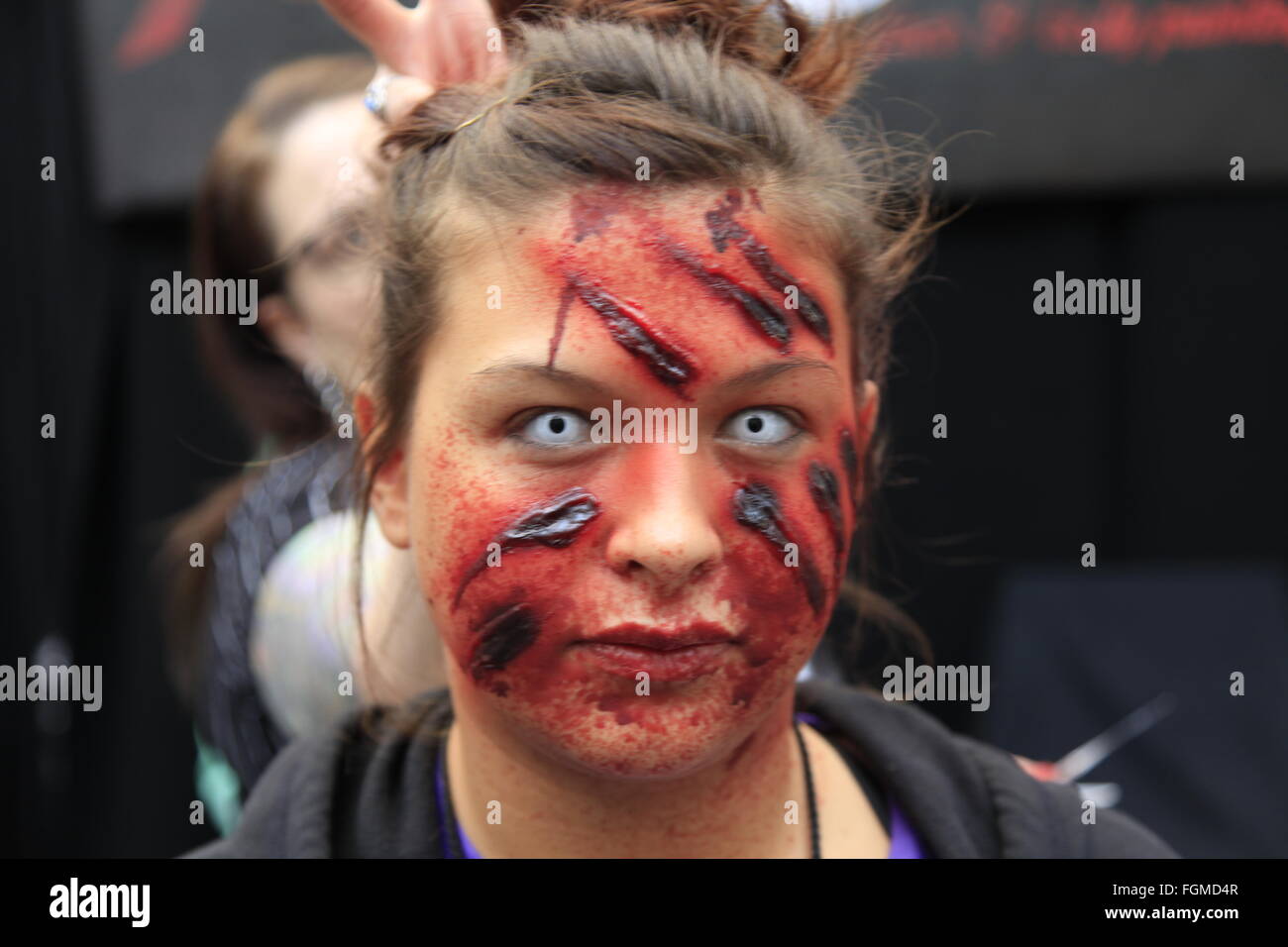 London, UK. 21st February, 2016. Walking Dead TV Convention Walker Stalker Con Olympia London 21/02/2016 walking dead fans gather to see stars of the show and stalls selling everything to do with the hit zombie American show photo ops with a star or zombie. cosplayers & undead walkers roaming the event floor entertaining the crowds. Stalls selling make-up and characters from the show. Credit:  Paul Thompson/Alamy Live News Stock Photo