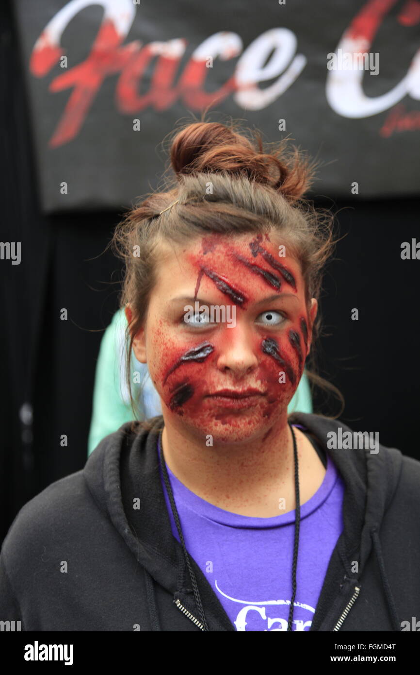 London, UK. 21st February, 2016. Walking Dead Convention Walker Stalker Con Olympia London 21/02/2016 walking dead fans gather to see stars of the show and stalls selling everything to do with the hit zombie American show photo ops with a star or zombie. cosplayers & undead walkers roaming the event floor entertaining the crowds. Stalls selling make-up and characters from the show. Credit:  Paul Thompson/Alamy Live News Stock Photo