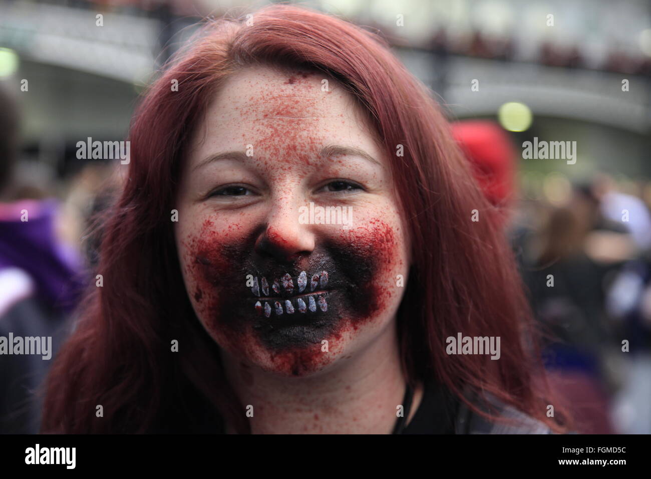 London, UK. 21st February, 2016. Walking Dead Convention Walker Stalker Con Olympia London 21/02/2016 walking dead fans gather to see stars of the show and stalls selling everything to do with the hit zombie American show photo ops with a star or zombie. cosplayers & undead walkers roaming the event floor entertaining the crowds. Stalls selling make-up and characters from the show. Credit:  Paul Thompson/Alamy Live News Stock Photo