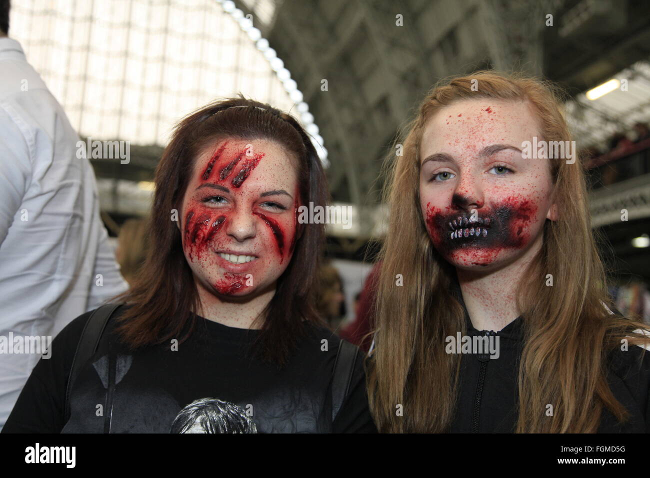 London, UK. 21st February, 2016. Walking Dead Convention Walker Stalker Con Olympia London 21/02/2016 walking dead fans gather to see stars of the show and stalls selling everything to do with the hit zombie American show photo ops with a star or zombie. cosplayers & undead walkers roaming the event floor entertaining the crowds. Stalls selling make-up and characters from the show. Credit:  Paul Thompson/Alamy Live News Stock Photo