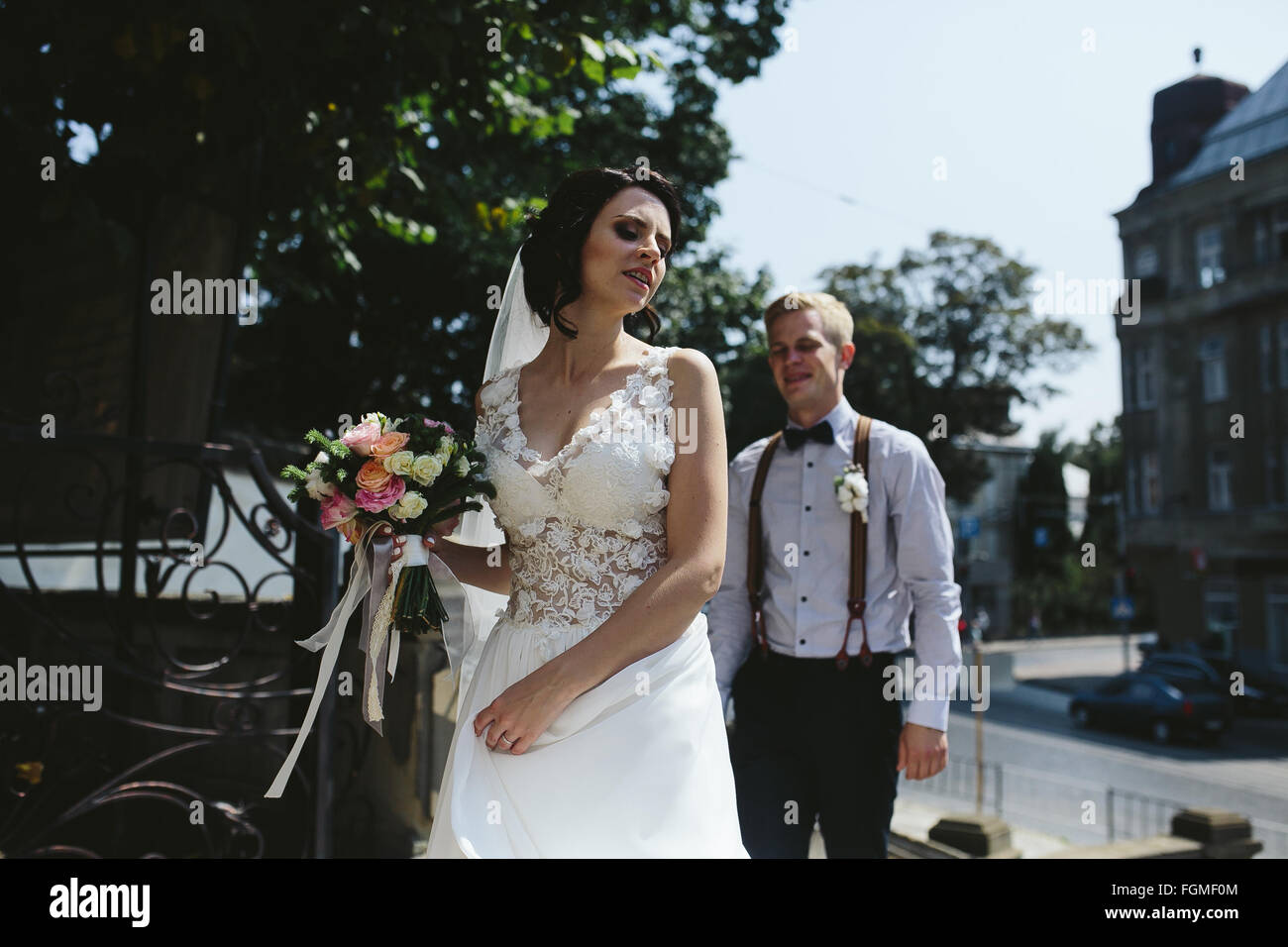 bride and groom posing on the streets Stock Photo - Alamy