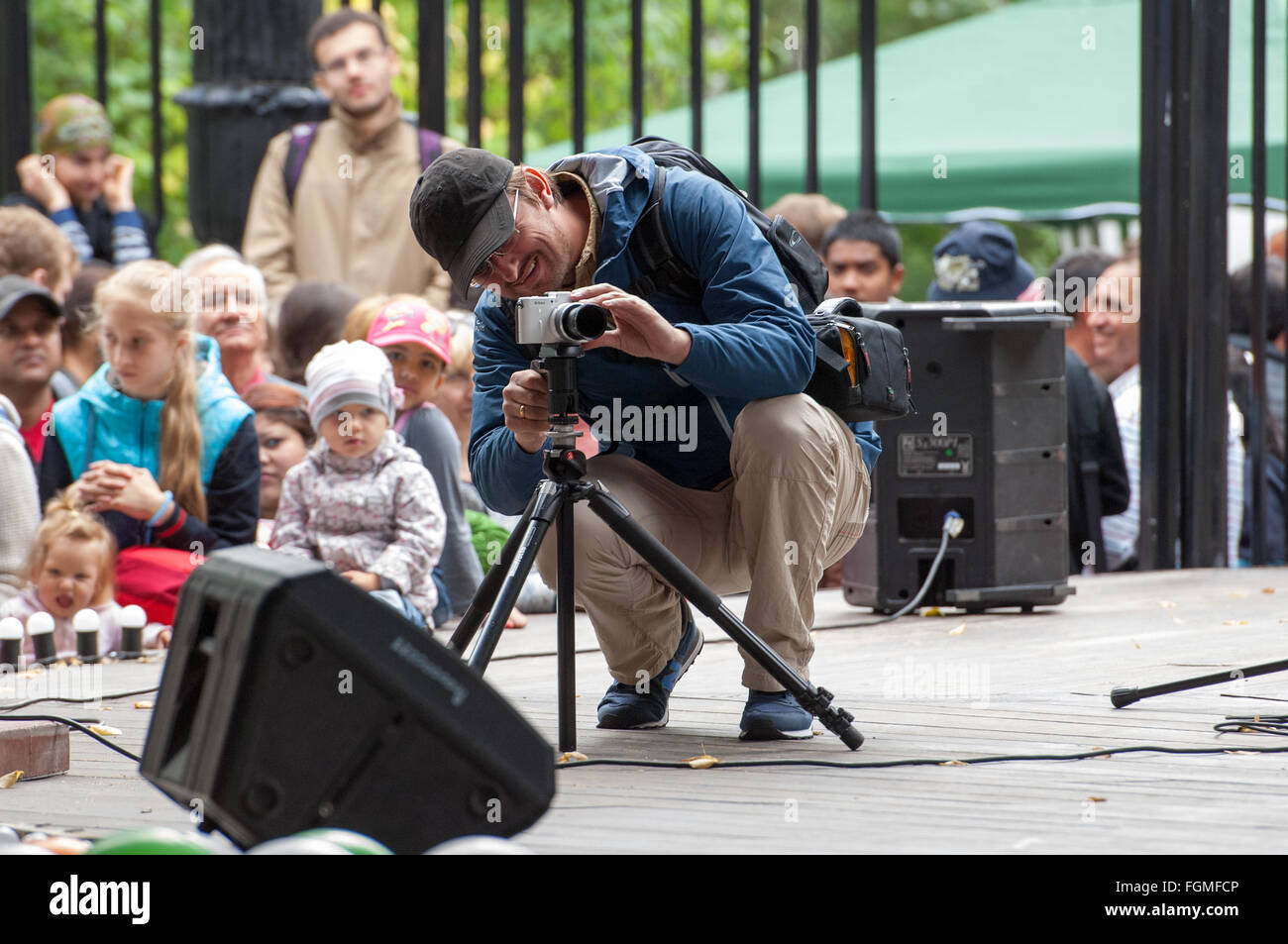 RUSSIA, MOSCOW - AUGUST 16, 2015: Unidentified man with tripod filming an event on Independence Day of India in Sokolniki park, Moscow, Russia Stock Photo