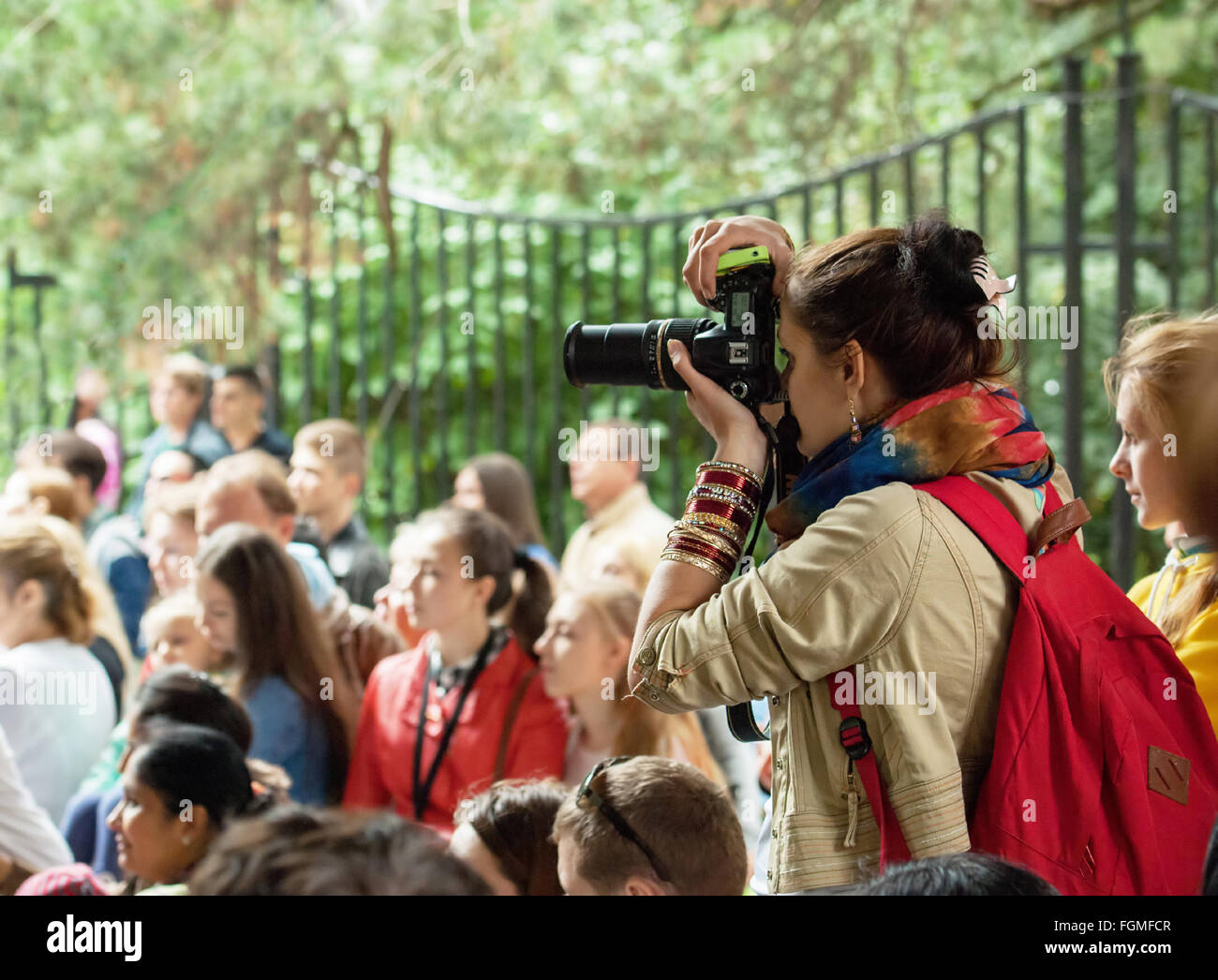 RUSSIA, MOSCOW - AUGUST 16, 2015: Unidentified woman filming an event during Independence Day of India in Sokolniki park, Moscow, Russia Stock Photo