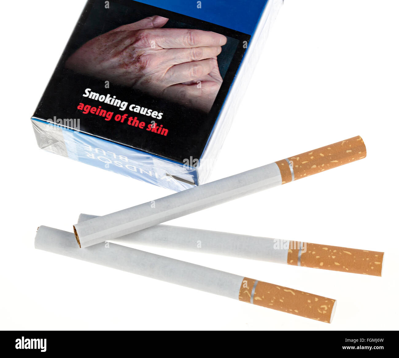 Cigarettes with packet and warning that smoking causes ageing of the skin, UK Stock Photo