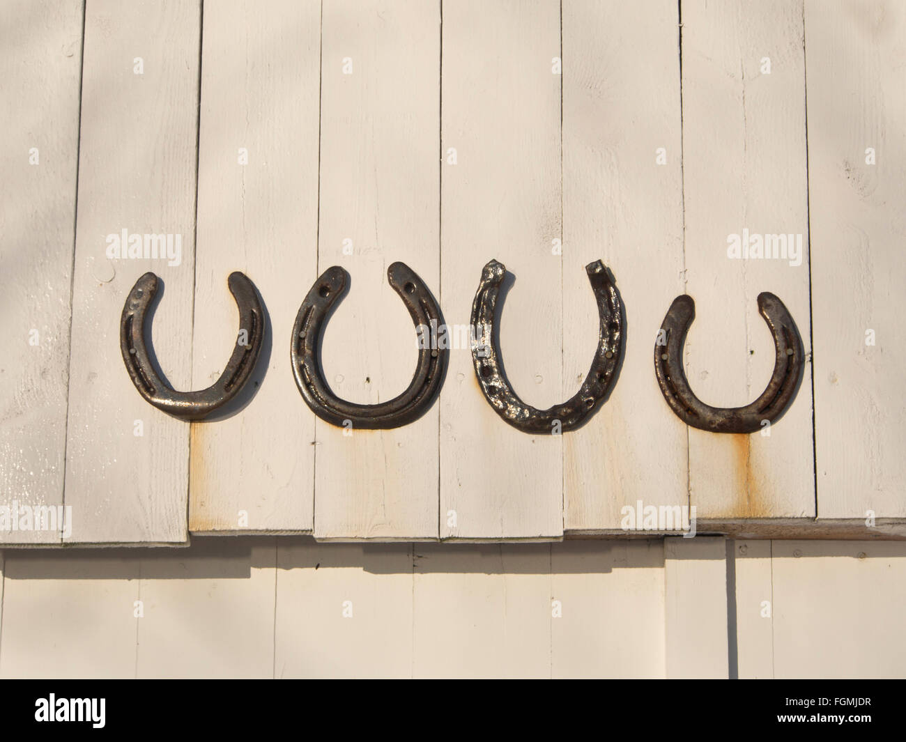 Superstition, four times good luck, iron horseshoe nailed turned up on the wall above a door is said to capture luck, in Norway Stock Photo