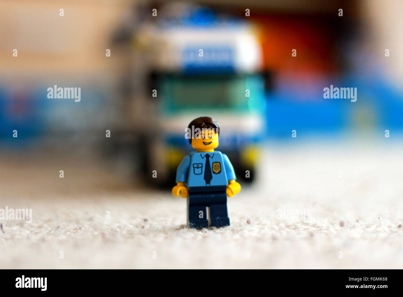 Lego figure of policeman with truck in background Stock Photo
