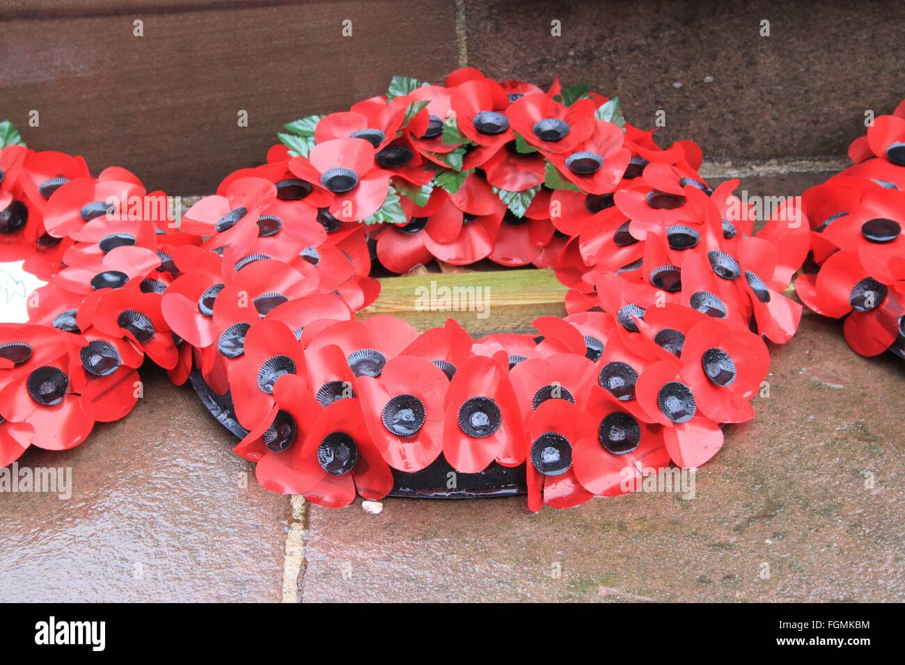 Poppy wreath on the War Memorial in the rain Stock Photo