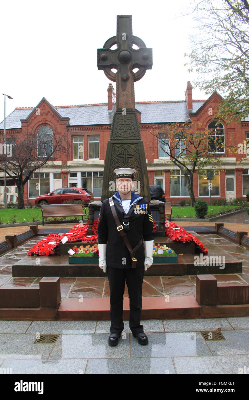 War Memorial, Ramsey, Isle of Man, Armistice Day after the ceremony a sailor from HMS Ramsey stands to attention Stock Photo