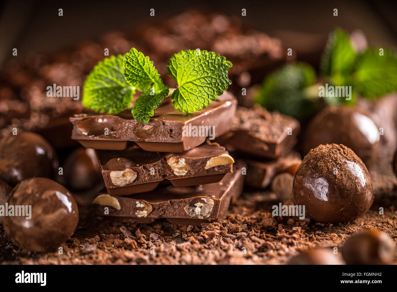 Composition of chocolate sweets, cocoa and spices on wooden background Stock Photo