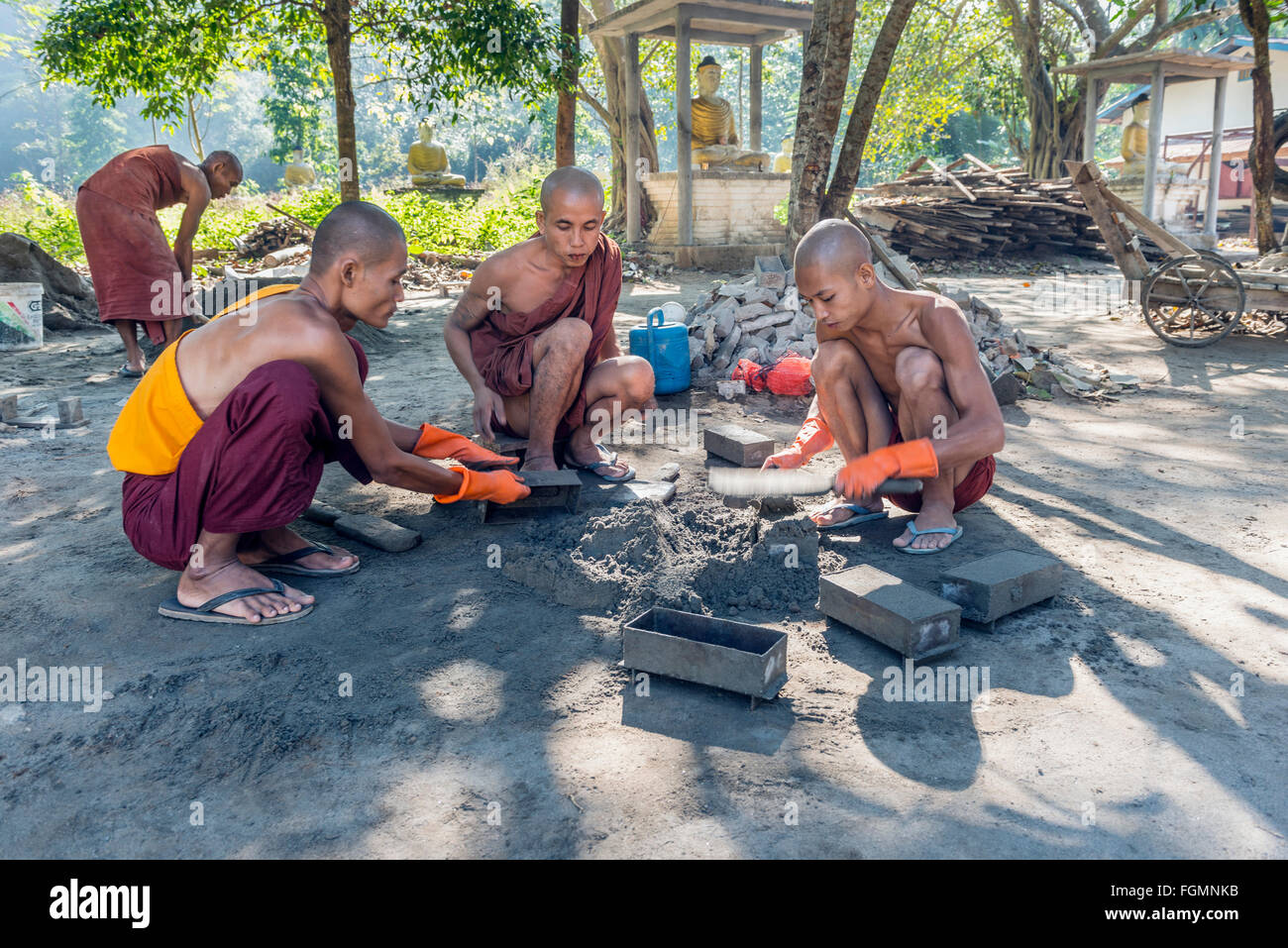 Monks making bricks, Burma Stock Photo