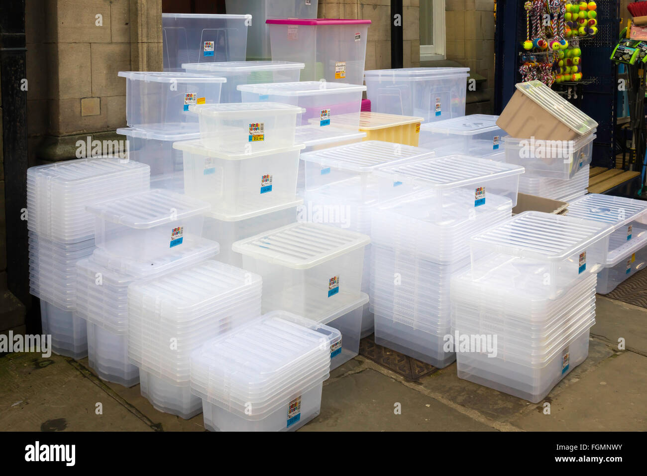Plastic storage boxes of various sizes for sale outside an English Hardware Store Stock Photo