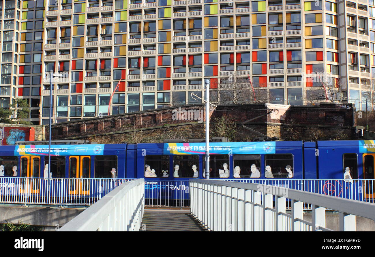 A Sheffield Supertram passes by regenerated flats on the Park Hill housing estate in Sheffield, England UK Stock Photo