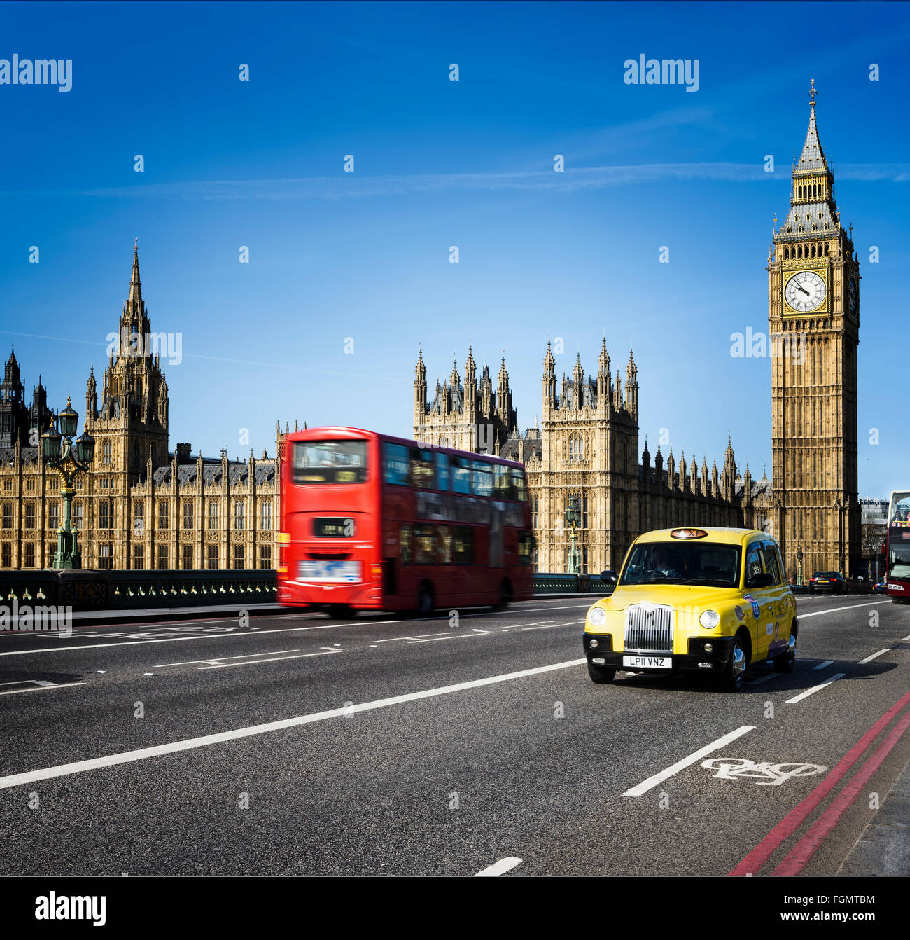 LONDON - APRIL 12, 2015 : London Bus and traditional taxi with Big Ben on April 12, 2015 in London, England. Stock Photo