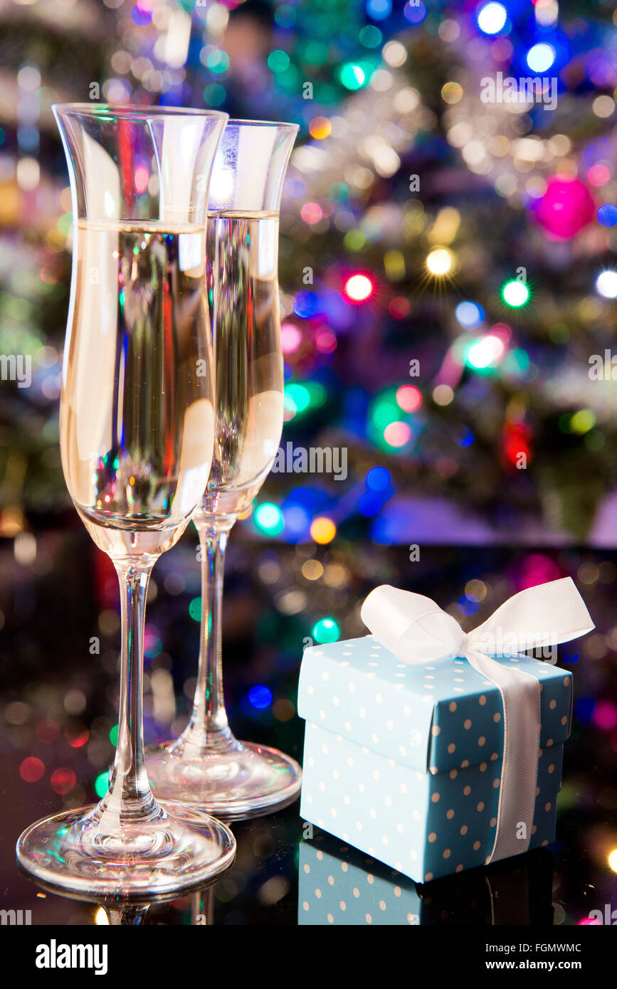 Two glasses of champagne and a blue gift Stock Photo