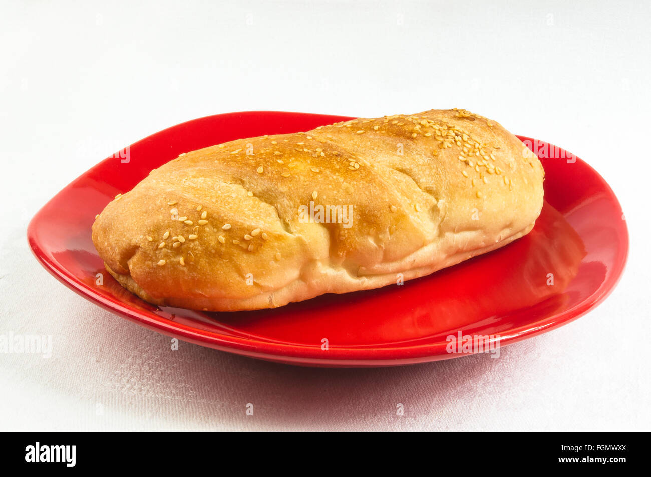 whole wheat breads and bun on red plate Stock Photo - Alamy