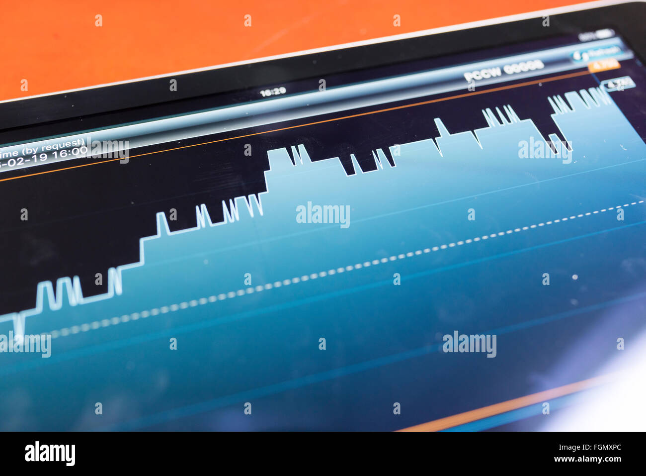 Tablet with stock graph on a wood table Stock Photo