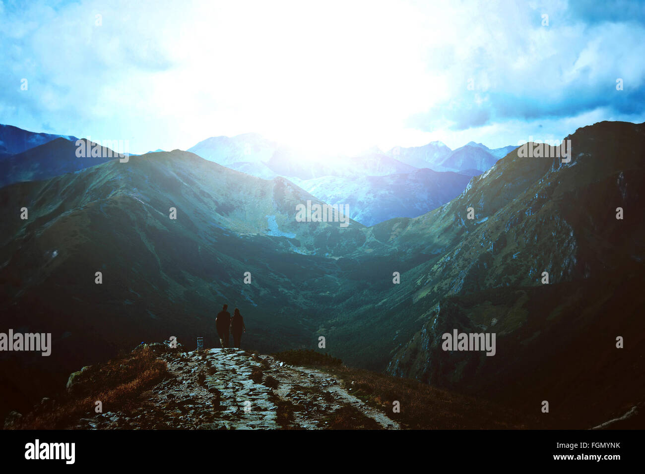 Tourism in mountains. A couple of tourists in dark mountains. Travel and nature image. Stock Photo