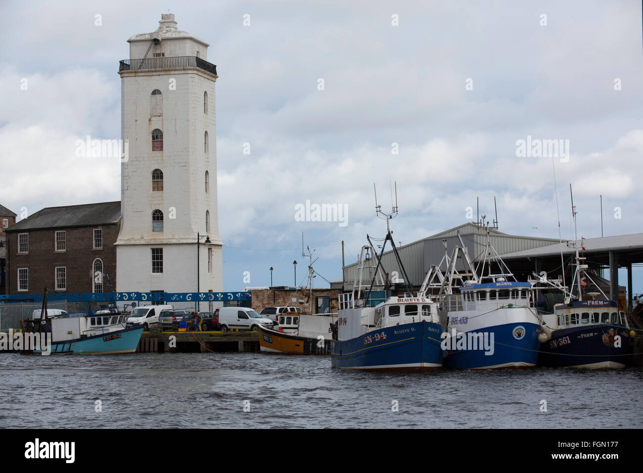 Fishing boats at the North Shields Fish Quay in north-east England. The Low Light tower overlooks the harbour. Stock Photo