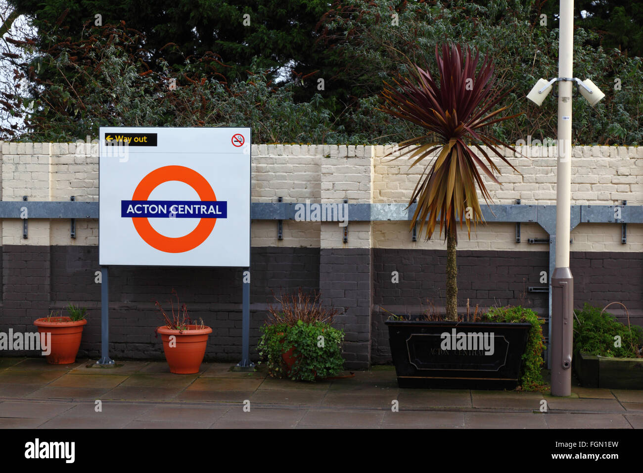Pot plants and sign on platform at Acton Central Overground station, Acton, London, England Stock Photo
