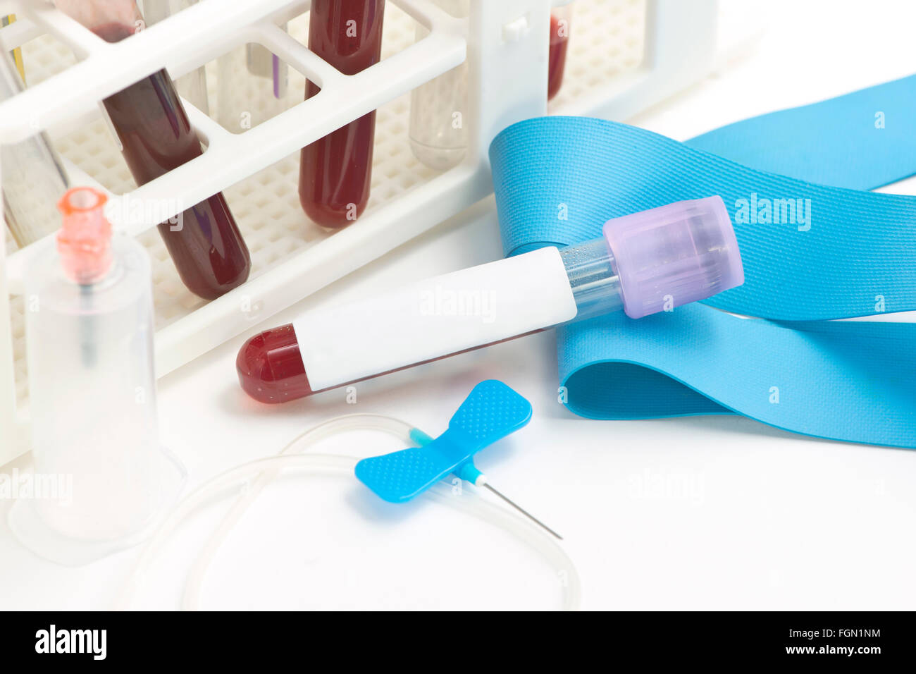 Blood collection tube with tube rack and catheter.  Labels and document are fictitious and created by the photographer. Stock Photo