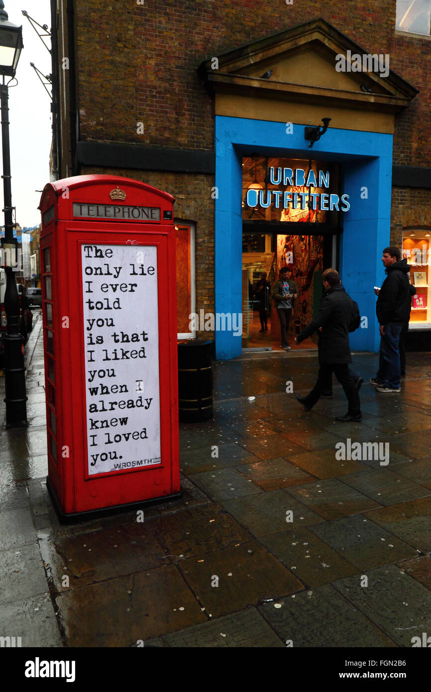 Quotation on old red telephone box, Seven Dials, near Covent Garden, London, England Stock Photo