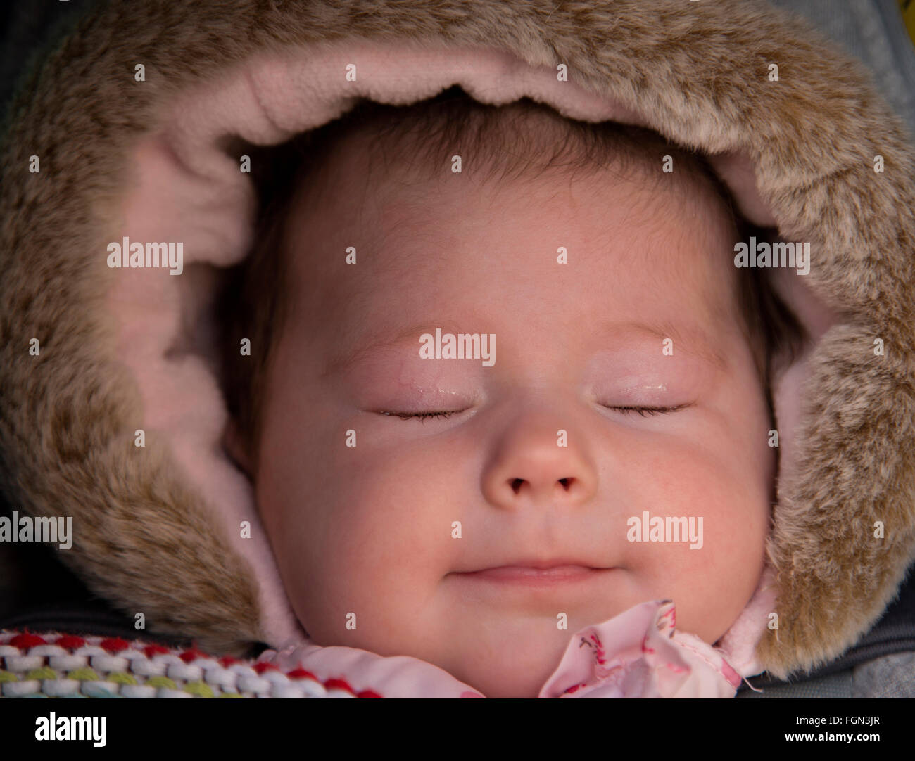 close up portrait of sleeping baby girl in winter Stock Photo