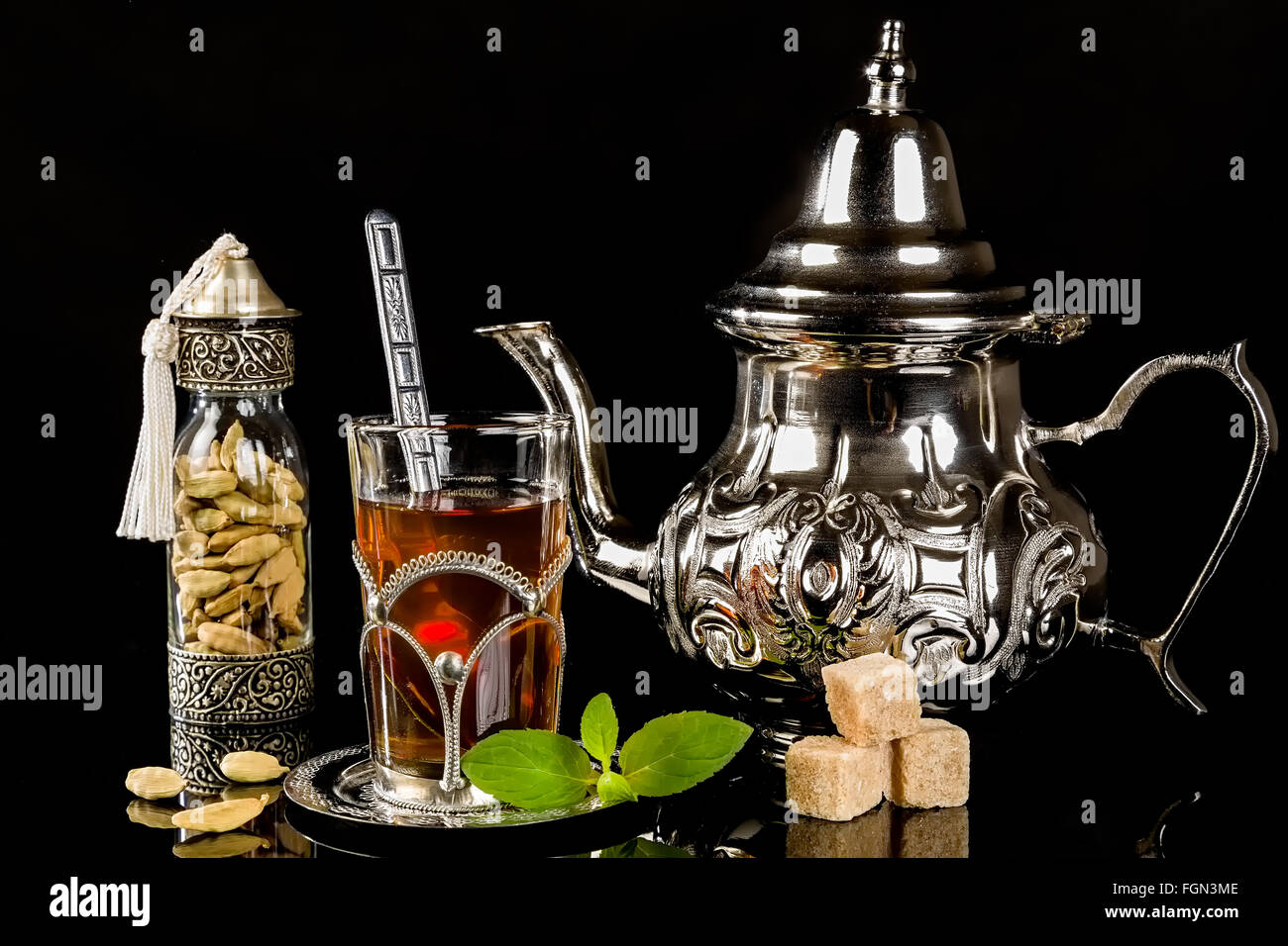 Arabic mint tea and cardamon seeds on the black background Stock Photo