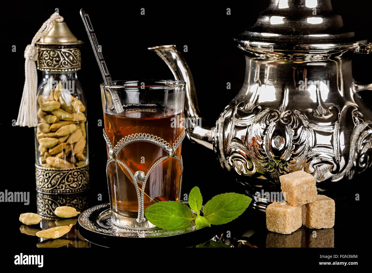 Arabic mint tea and cardamon seeds on the black background Stock Photo