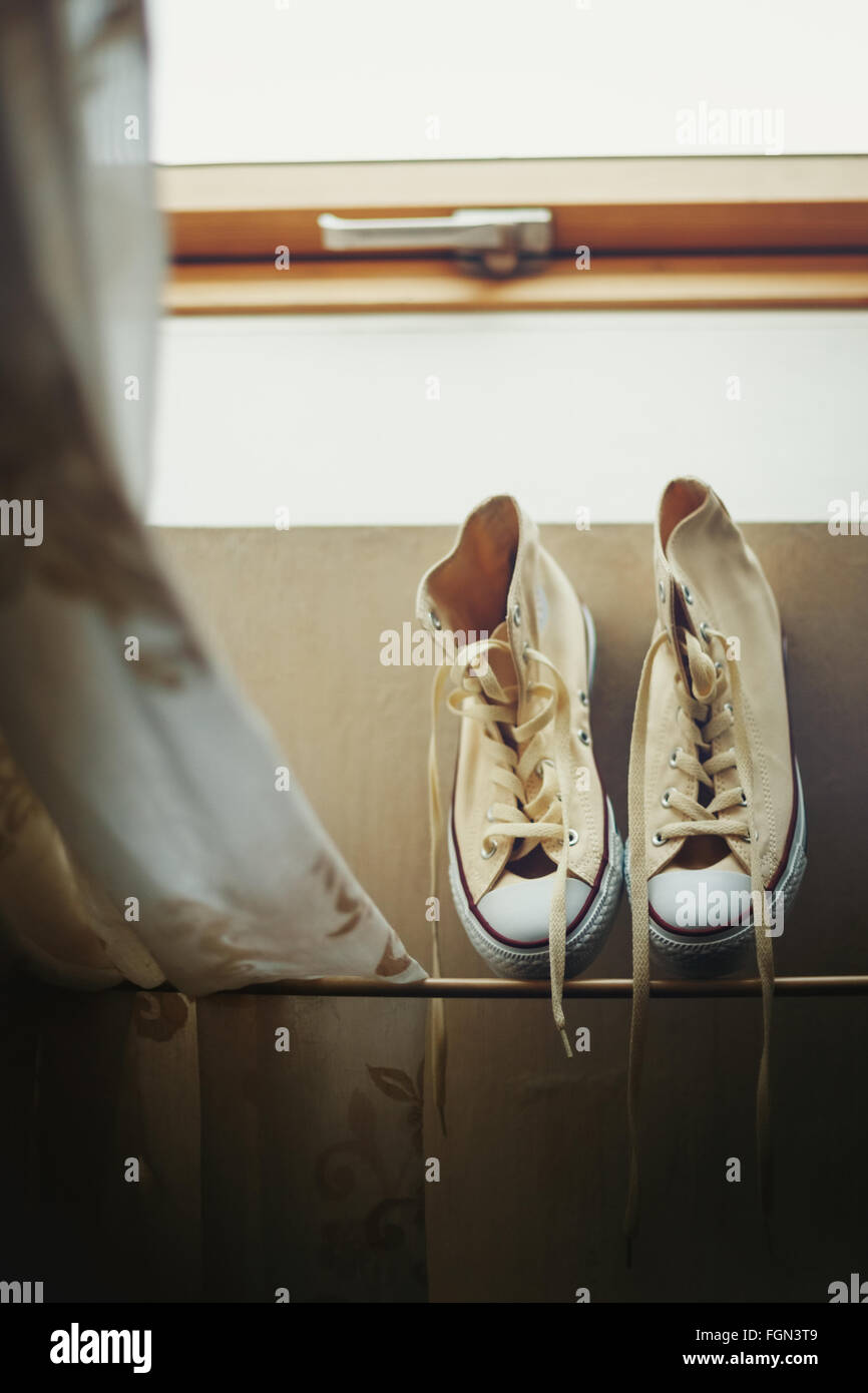 Beige Sneakers Getting Dried Near Window. Image Toned. Selective Focus. Stock Photo