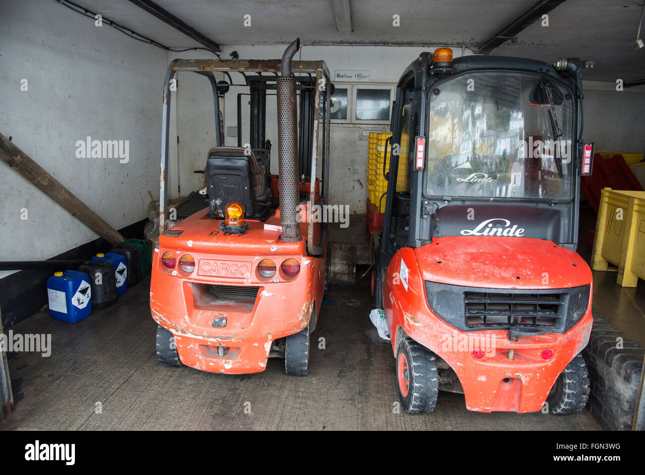 Two orange forklifts Stock Photo - Alamy