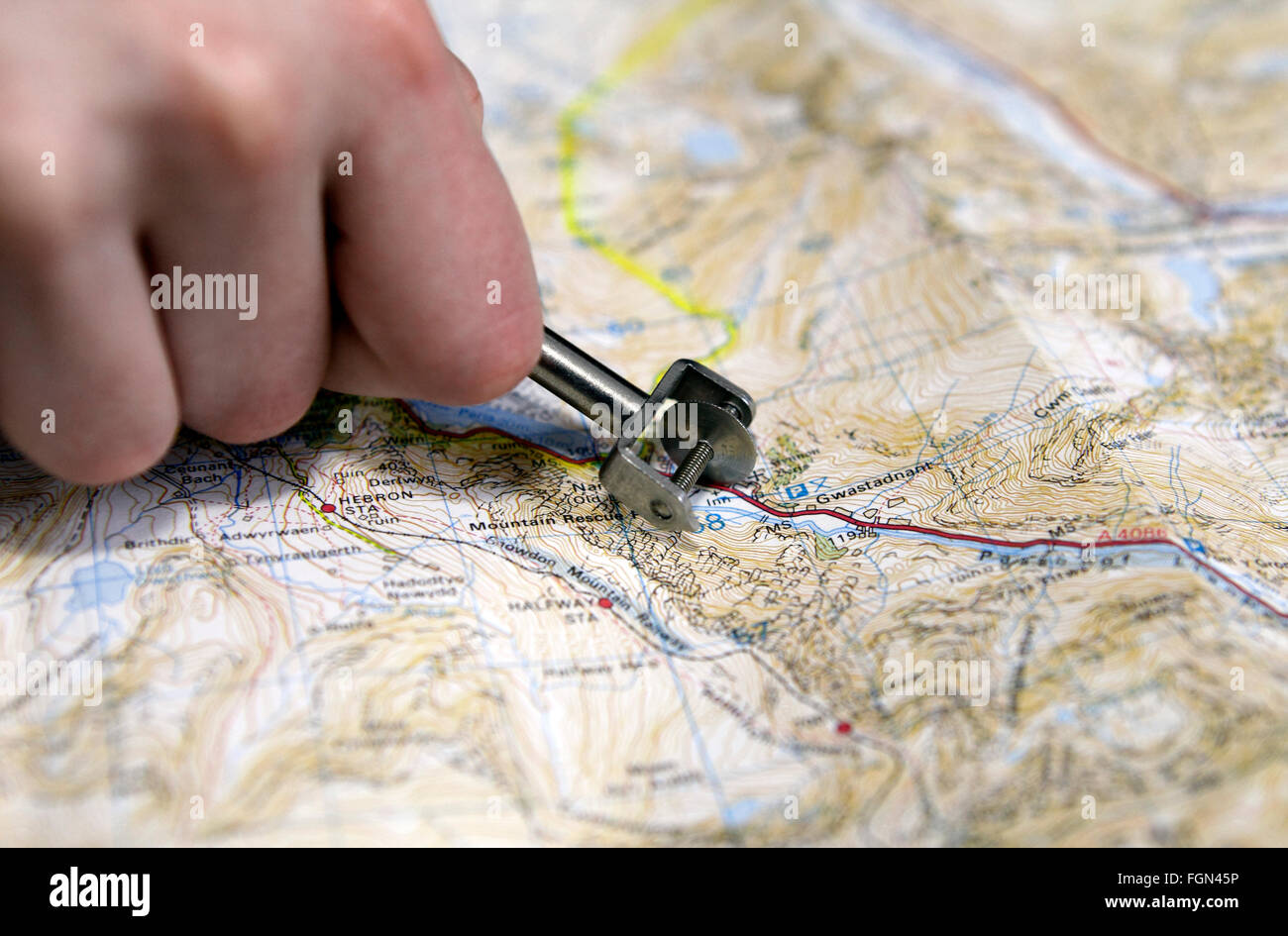 Map measuring tool called a curivmeter or opisometer. Wheel on a