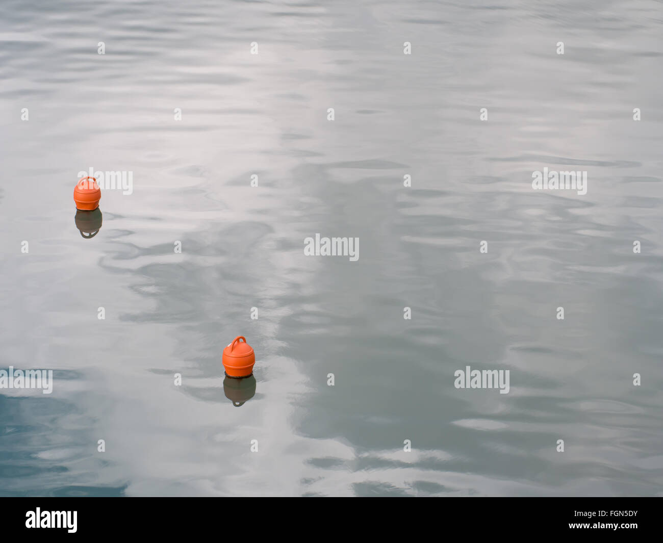 Calm sea scene. Mooring buoys on gently moving waves. Stock Photo