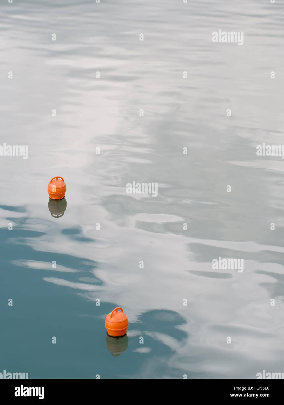 Calm sea scene. Buoys and lapping waves. Vertical composition. Stock Photo