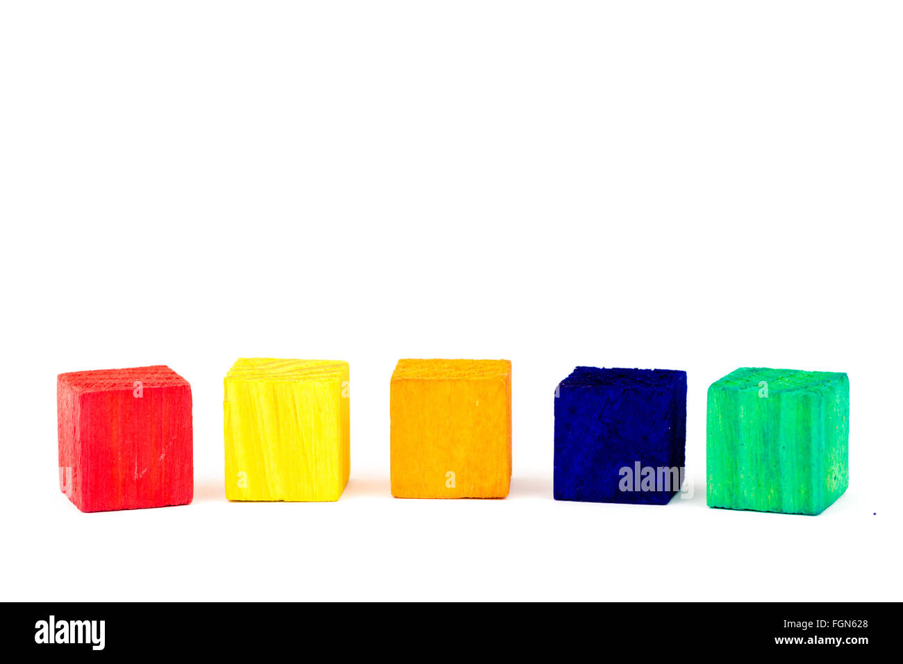 Five toy wooden colored blocks isolated on white background, copy space ...