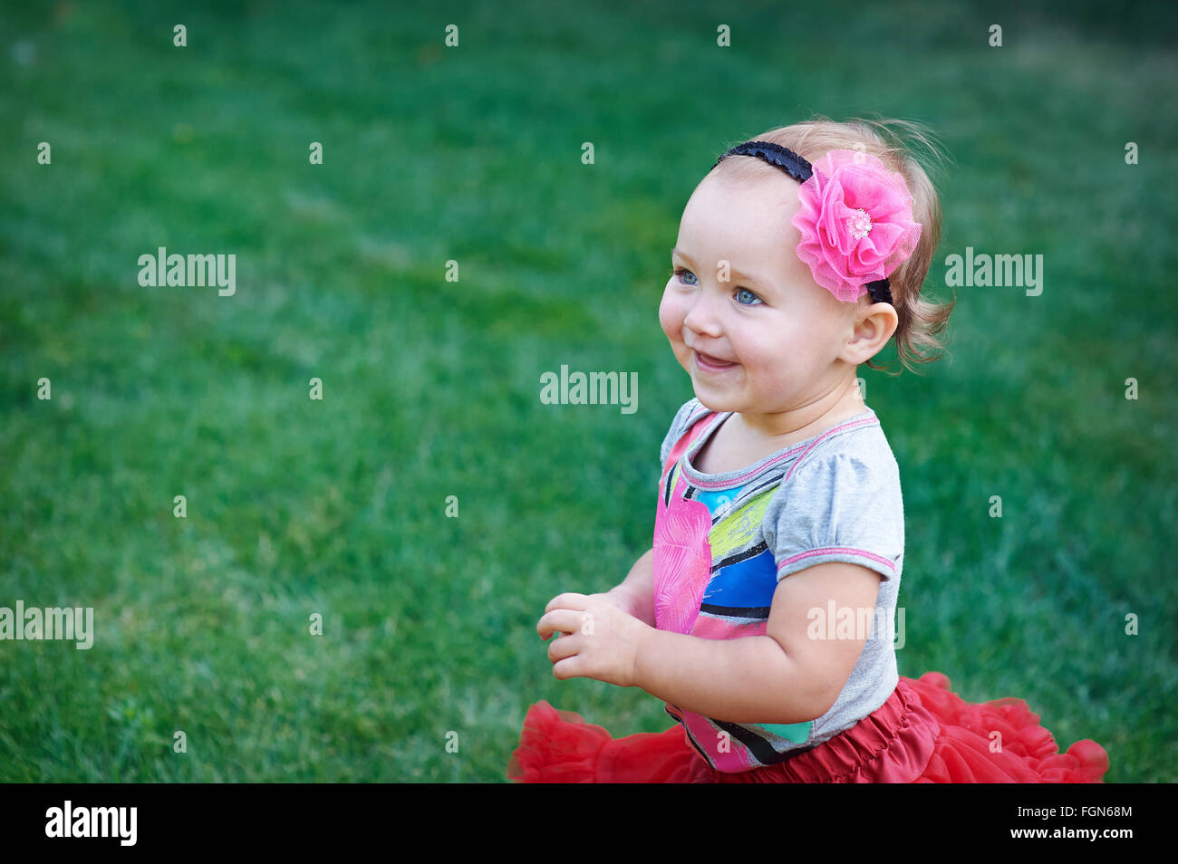 little happy cheerful girl running around playing and having fun Stock Photo