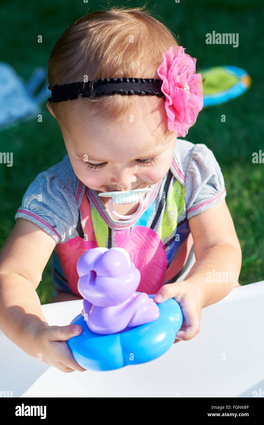 cute little girl playing with toys Stock Photo - Alamy