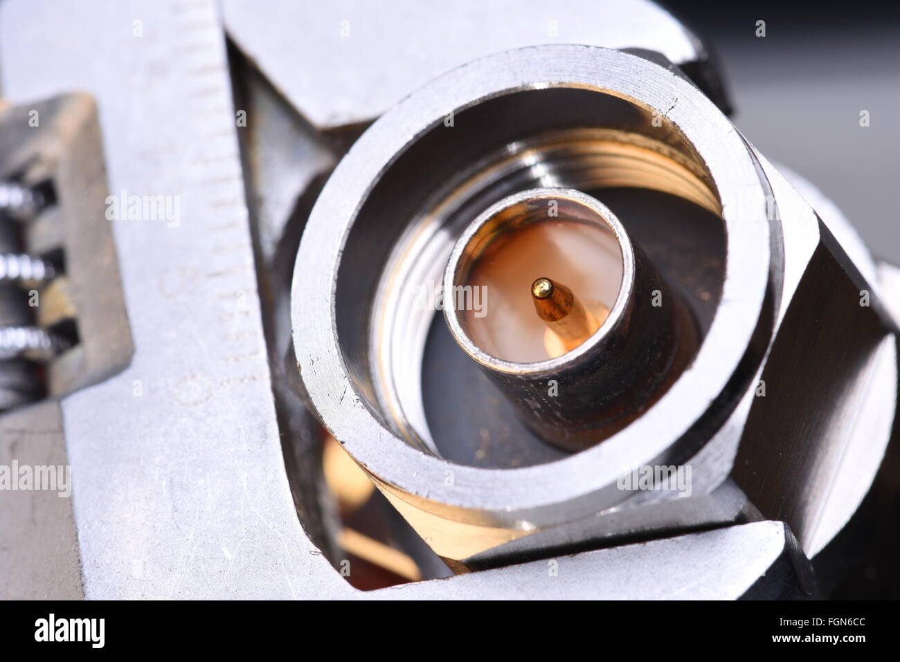 Closeup of coax connector with tool wrench, coaxial network technology