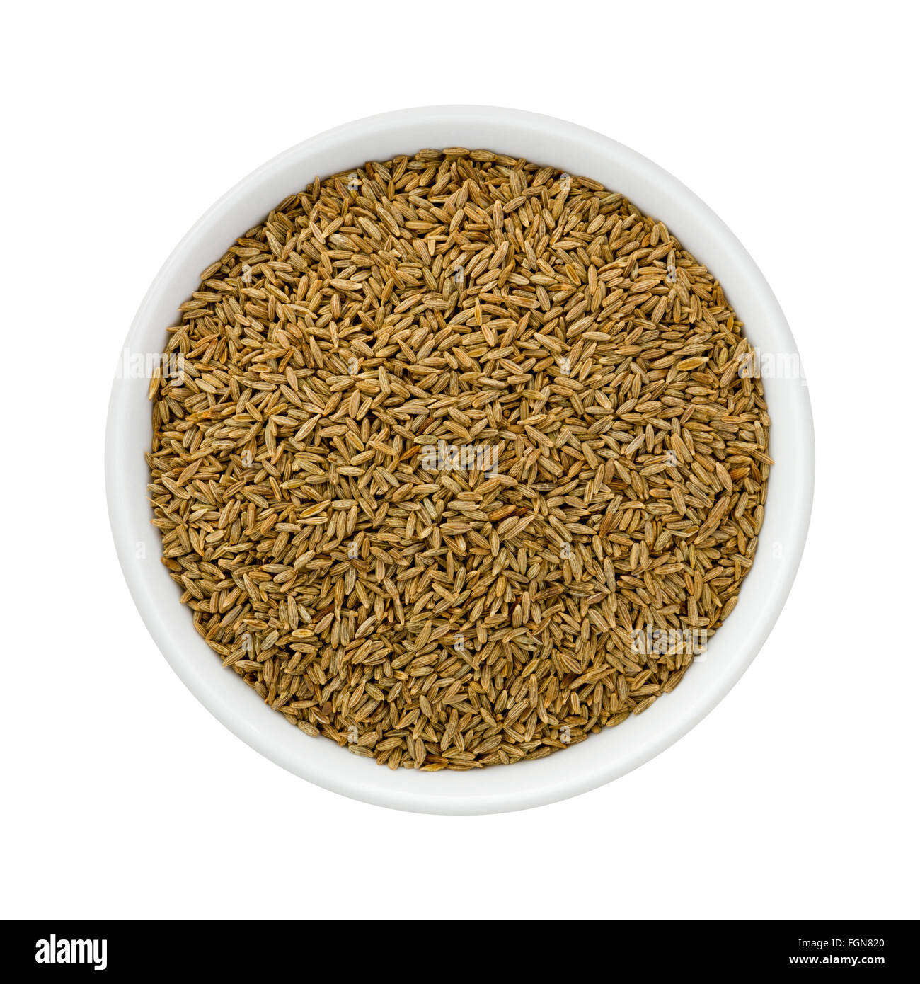Cumin Seed in a Ceramic Bowl. The image is a cut out, isolated on a white background. Stock Photo