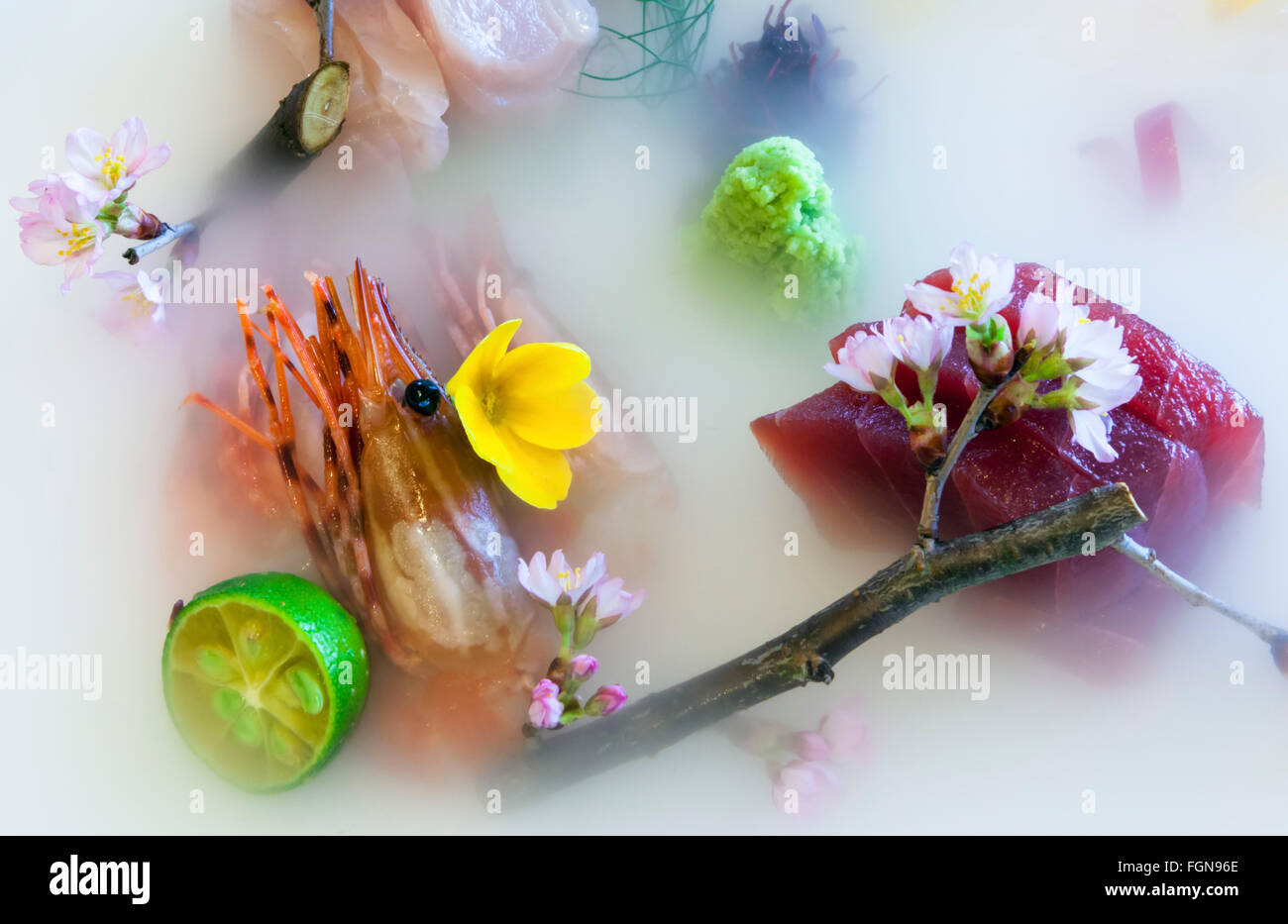 Gourmet Sashimi served in dry ice with an Asian lime or calamansi Stock Photo