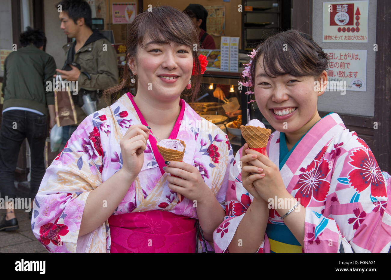 Tokyo Japan teenagers in Kimonos having ice cream in Sensoji Temple relaxing and smiling  at Tokyo's oldest temple Model Release Stock Photo