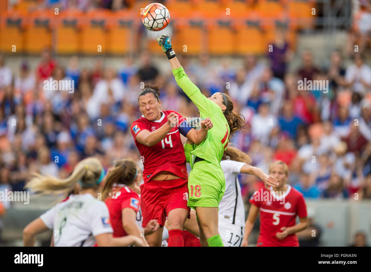 Houston, TX, USA. 21st Feb, 2016. Canada goalkeeper Stephanie Labbe (18) punches the ball away past Canada forward Melissa Tancredi (14) following a US corner kick during the Final match of the CONCACAF Olympic Qualifying tournament between Canada and the USA at BBVA Compass Stadium in Houston, TX. USA won 2-0.Trask Smith/CSM/Alamy Live News Stock Photo
