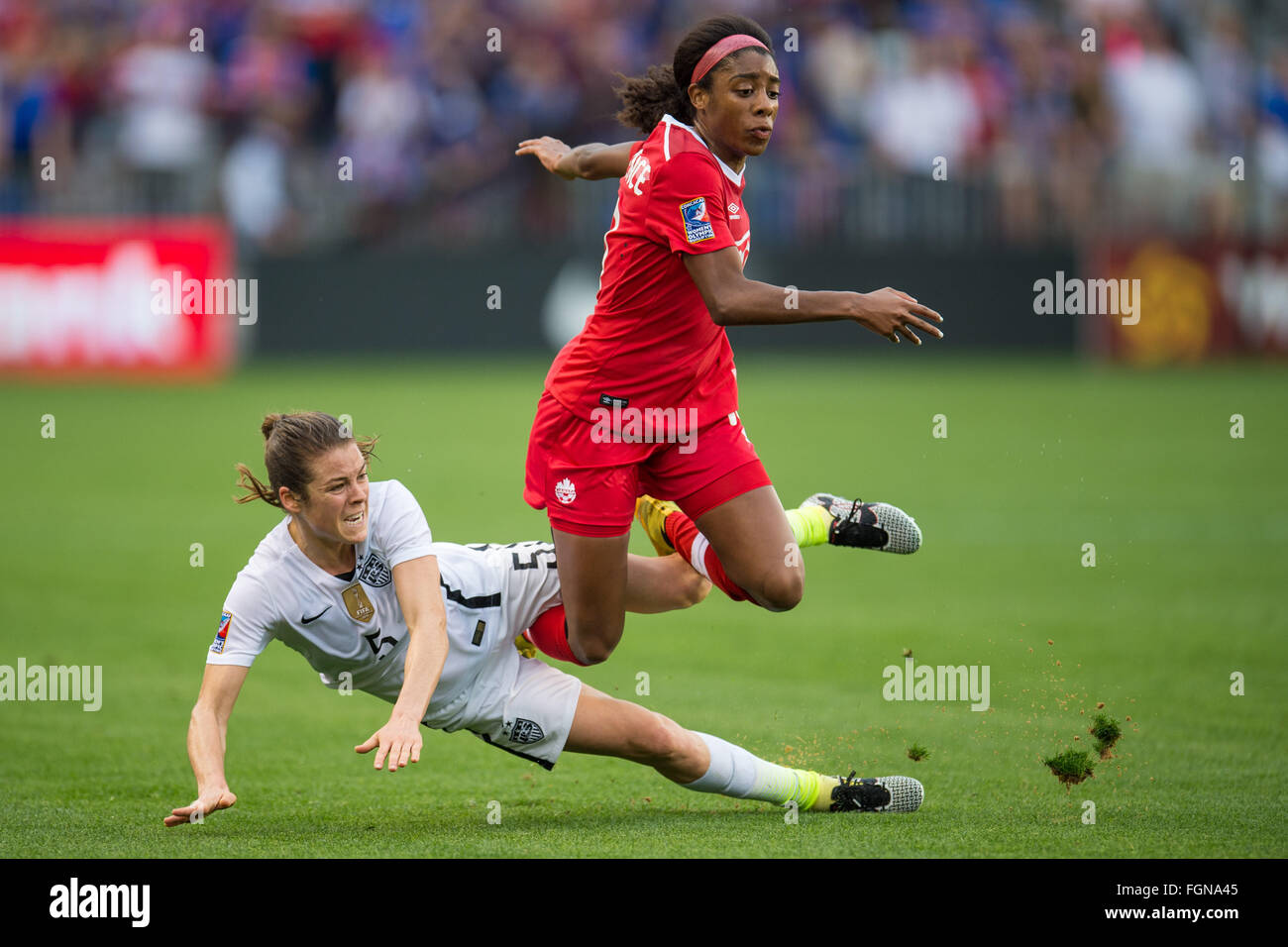 Houston, TX, USA. 21st Feb, 2016. United States defender Kelley O'Hara (5) and Canada midfielder Ashley Lawrence (10) get tangled up during the Final match of the CONCACAF Olympic Qualifying tournament between Canada and the USA at BBVA Compass Stadium in Houston, TX. USA won 2-0.Trask Smith/CSM/Alamy Live News Stock Photo