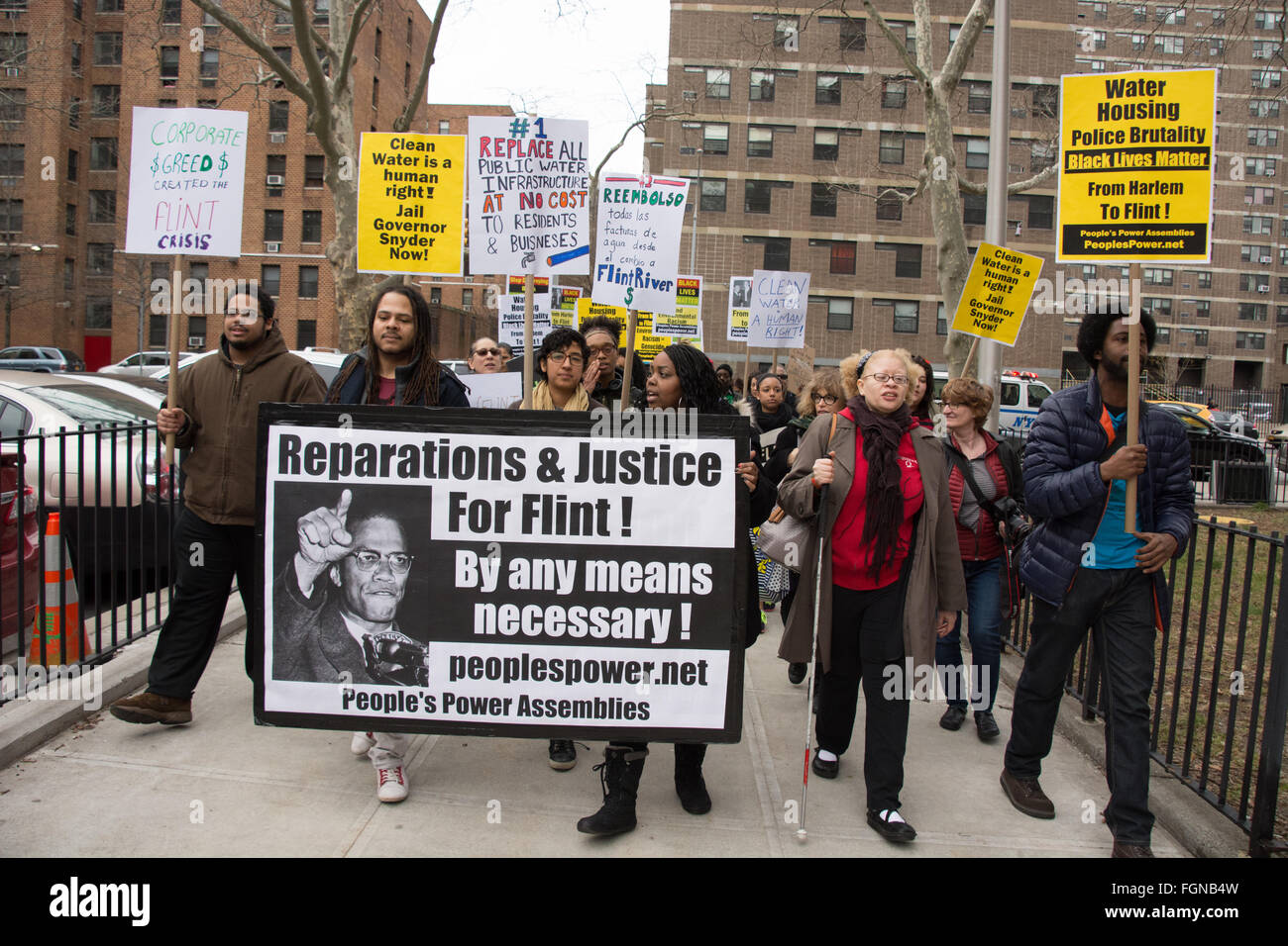 Harlem, New York, USA. 21st February 2016. Social and environmental justice activists march through Harlem after a solidarity rally for Flint, Michigan at the Adam Clayton Powell Jr. State Office Building on the 51st anniversary of the assassination of Malcolm X. Stock Photo