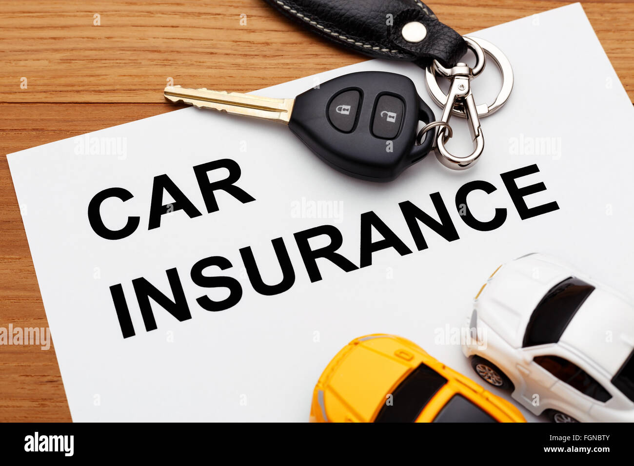 Car insurance concept with car key on wood table Stock Photo