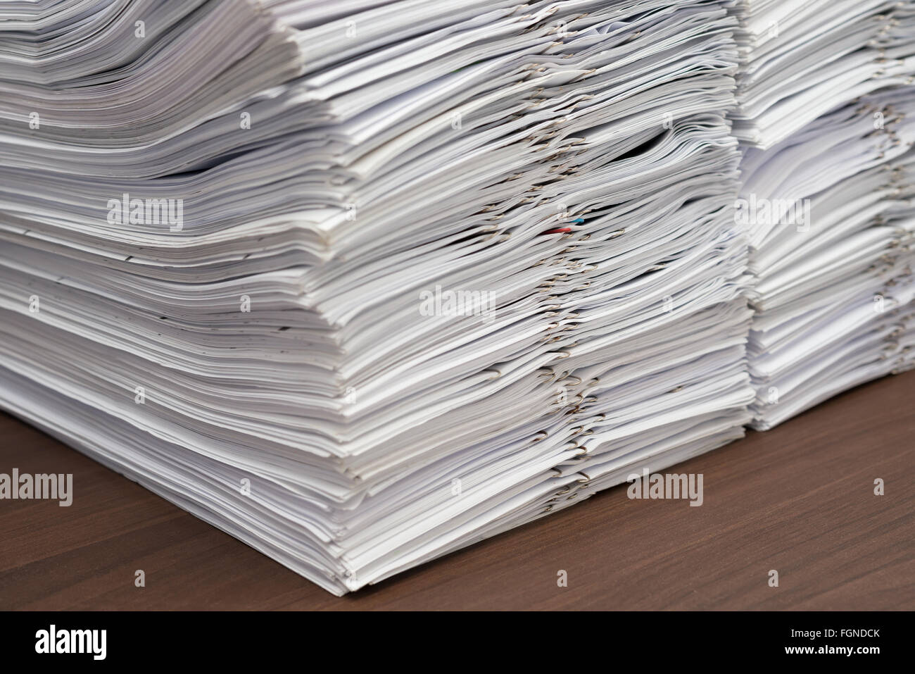 Pile of documents with clips on desk stack up Stock Photo