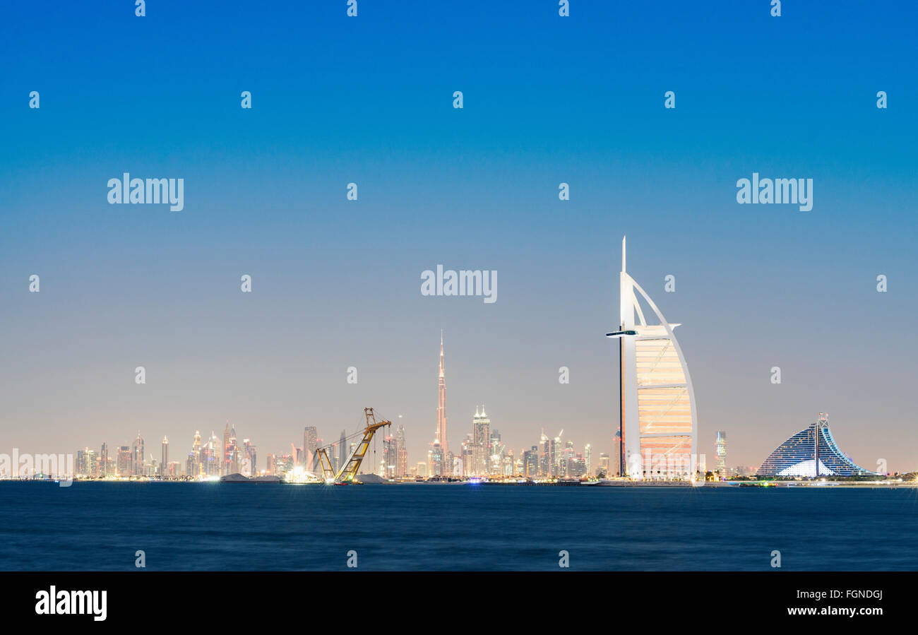 Skyline at night of Dubai waterfront with Burj al Arab Hotel in United Arab Emirates Stock Photo