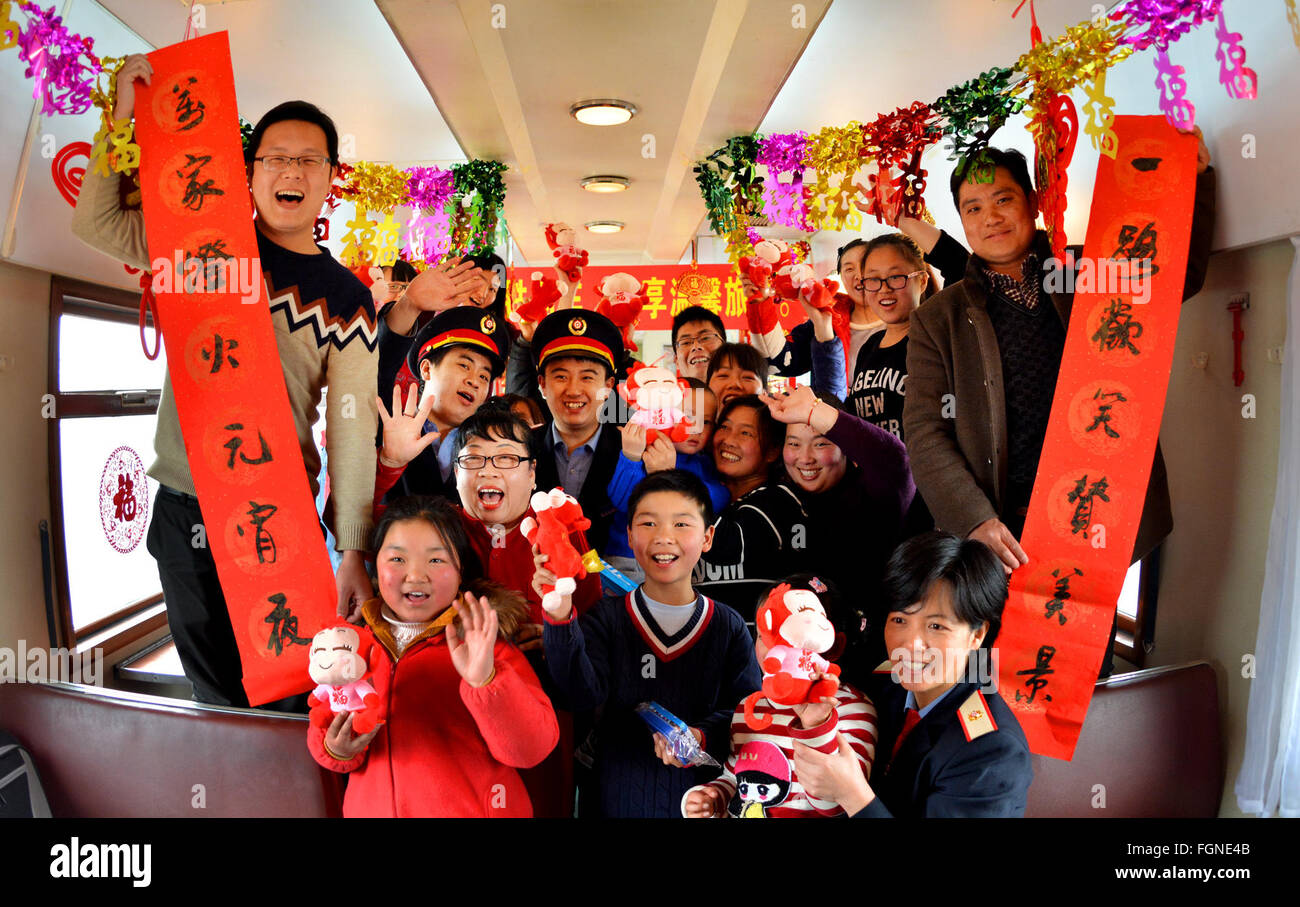 Tianjin, China. 22nd Feb, 2016. Crew members of K4204 train pose for a photo with passengers to celebrate the Lantern Festival in Tianjin, north China, Feb. 22, 2016. Chinese people celebrated the traditional Lantern Festival, the fifth day of the first month in lunar calender, on Feb. 22. Credit:  Yang Baosen/Xinhua/Alamy Live News Stock Photo